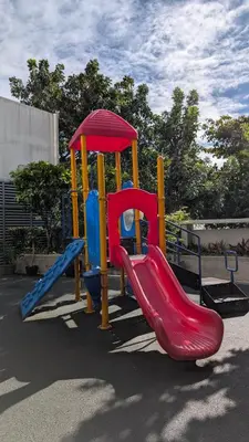 a playground with a slide in a park at J&M Cozy Retreat - McKinley Hill, BGC in Manila