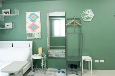 a bathroom with a shower and a bed and a mirror at The Beacon Condo T2-Studio in Manila