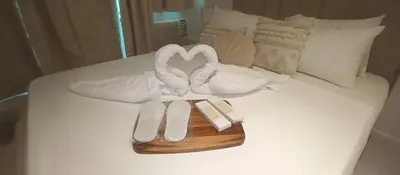 a bed with two swans in the shape of a heart at Casa Crisav Staycation place at AZURE in Manila