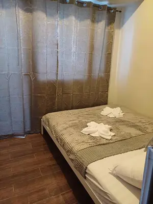 a bedroom with a bed with two white towels on it at Urban Space 1BR with Balcony in Manila