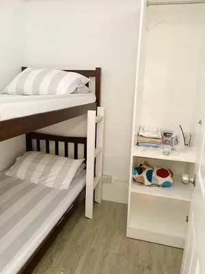 a bedroom with two bunk beds and a closet at AA Cozy Comfort in Nuvali in Calamba