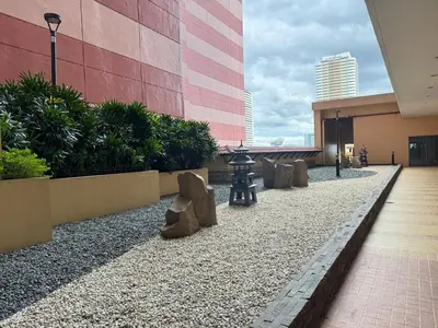 a walkway in a building with rocks and a building at Grand Riviera Suites 1202 front of US Embassy by Prime Stay in Manila