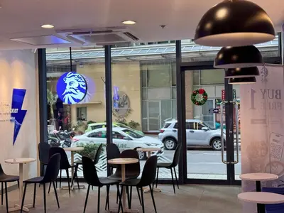 a restaurant with tables and chairs in front of a store at Grand Riviera Suites 1202 front of US Embassy by Prime Stay in Manila