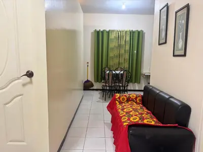 a living room with a couch and a green shower at Las Asturias in Balibago