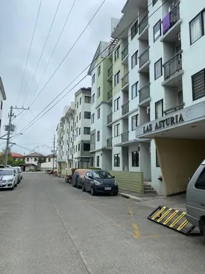 a street with cars parked in front of buildings at Las Asturias in Balibago
