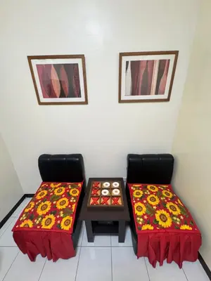 a room with two chairs and a table with two blankets at Las Asturias in Balibago