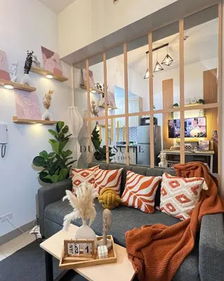 a living room with a couch and a table at Cozy Vibes near MOA & NAIA AIRPORT with NETFLIX,MINIVIDEOKE,BOARDGAMES-DUXE6 in Manila