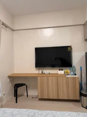a flat screen tv sitting on top of a wooden cabinet at Morgan Suites Executive Residences 2 in Manila