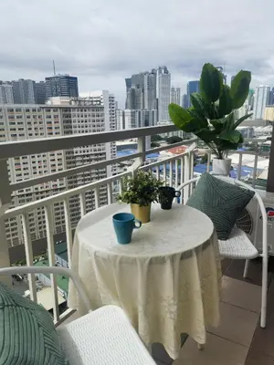 a table with potted plants on a balcony at pasig city resort condo in Manila