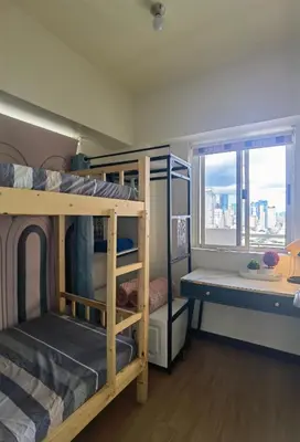 a bunk bed room with two bunk beds and a window at pasig city resort condo in Manila
