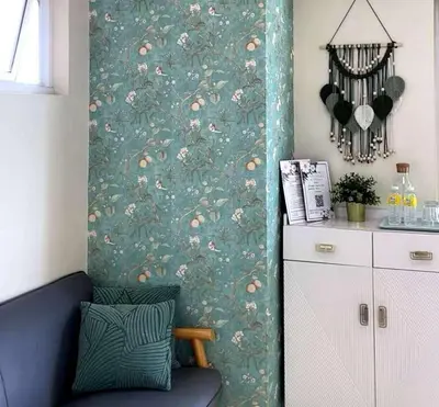 a living room with a wall with a green wallpaper at pasig city resort condo in Manila