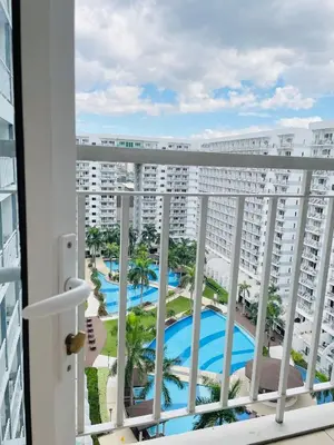 a view of the pool from the balcony of a resort at Shell Residences Condotel by Aiza in Manila