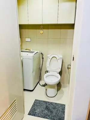 a small bathroom with a toilet and a sink at Shell Residences Condotel by Aiza in Manila