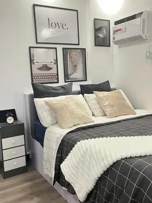 a bedroom with a bed with the words love on the wall at Aesthetic 2BR Penthouse near NAIA with Pool in Manila