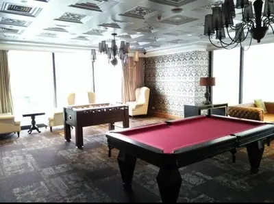 a living room with a pool table and a piano at Room with stunning view in Makati in Manila