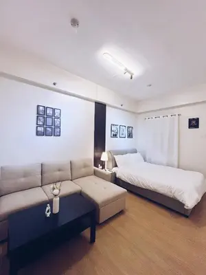 a living room with two beds and a couch at The Stars Lil' Suite in Trece Martires