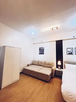 a bedroom with a couch and a bed in it at The Stars Lil' Suite in Trece Martires