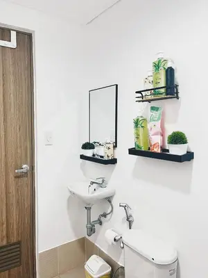 a bathroom with a sink and a mirror and a toilet at The Stars Lil' Suite in Trece Martires