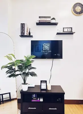a living room with a tv on a wall at The Stars Lil' Suite in Trece Martires