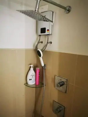 a shower head in the corner of a bathroom at Aldo shore 3 tower 2 mall of Asia in Manila