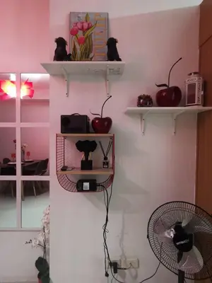 a room with two shelves with apples and a fan at Shell Residences Mall of Asia FAMILY ROOM in Manila