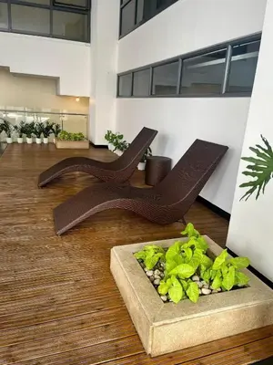 a room with two wooden benches on the floor at Studio in Greenbelt with Wifi, Pool and Gym in Manila