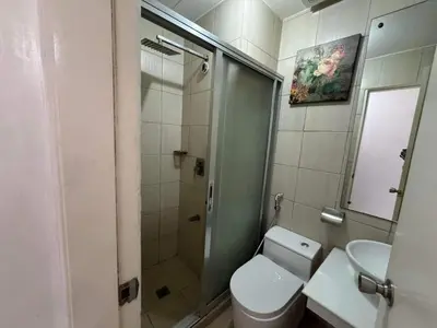 a bathroom with a shower and a toilet and a sink at Birch Tower a4 front of Robinson Mla FREEpool in Manila