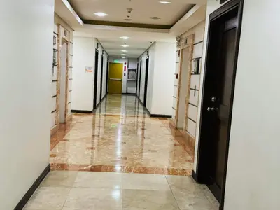 a hallway with a long corridor with white walls at Birch Tower a4 front of Robinson Mla FREEpool in Manila