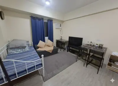 a bedroom with a bed and a desk and a desk at The Gamer's Hub in Manila