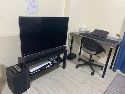 a desk with a television and a desk with a chair at The Gamer's Hub in Manila