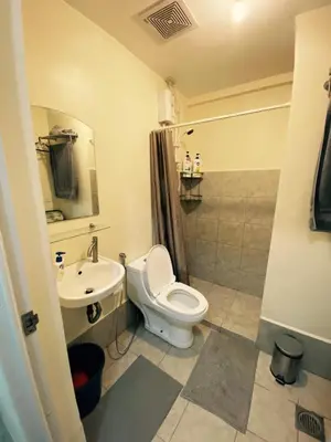 a bathroom with a toilet and a sink at The Gamer's Hub in Manila