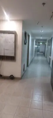 an empty hallway in a building with a sign on the wall at Florida sun condo in Manggahan