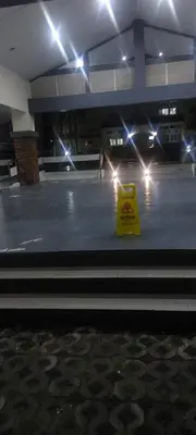 a caution sign on the floor of a building with lights at Florida sun condo in Manggahan