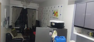 a living room with a refrigerator and a chair at Florida sun condo in Manggahan