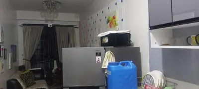 a kitchen with a refrigerator and a tv on top of it at Florida sun condo in Manggahan