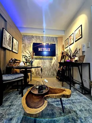 a living room with a netflix sign on the wall at Irene's Luscious Place in Manila