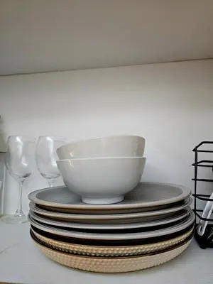 a stack of plates with a bowl on top at Irene's Luscious Place in Manila