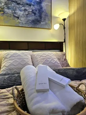a bed with a sign that says guest on it at Irene's Luscious Place in Manila