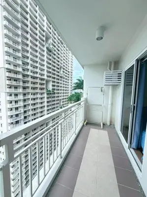 a balcony with white shutters on a building at Brixton Place in Manila