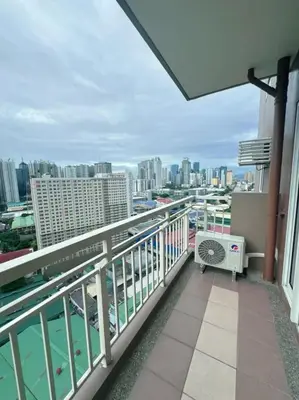 a balcony with a view of the city at Brixton Place in Manila