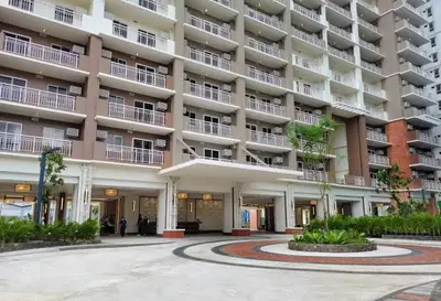 a large apartment building with a courtyard in front of it at Brixton Place in Manila