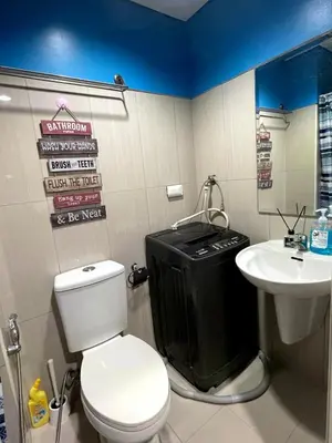 a bathroom with a toilet and a sink at MOA Shell Residences - Big Balcony Facing Pool in Manila