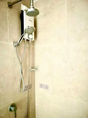 a shower in a bathroom with a shower head at The Rise Makati in Manila