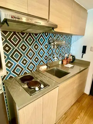 a kitchen with a stove and a sink in it at The Rise Makati in Manila