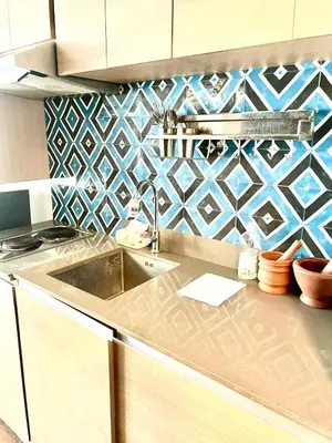 a kitchen with a sink and blue and white tiles at The Rise Makati in Manila