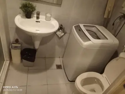 a small bathroom with a toilet and a sink at Jhang places sea residence in Manila