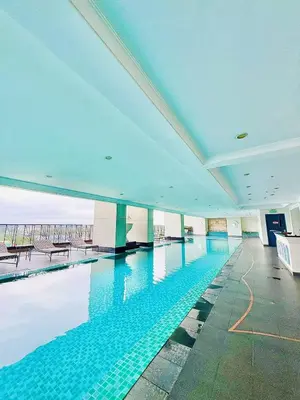 a large swimming pool in a large building at Vincondotel Malate Manila 2BR Admiral 2823 in Manila