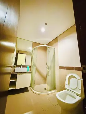 a bathroom with a shower and a toilet and a sink at Vincondotel Malate Manila 2BR Admiral 2823 in Manila