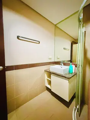 a bathroom with a sink and a mirror at Vincondotel Malate Manila 2BR Admiral 2823 in Manila