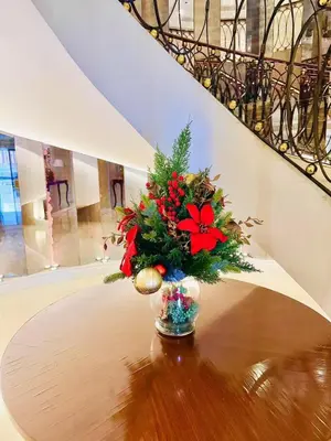 a vase with a christmas arrangement on a table at Vincondotel Malate Manila 2BR Admiral 2823 in Manila
